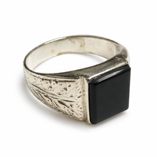 Load image into Gallery viewer, Side view of vintage 925 silver black agate men's signet ring featuring a square flat-top gemstone, engraved floral and geometric detailing, and a wide tapered band.