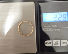 Load image into Gallery viewer, A thin gold ring is shown on a digital scale displaying a weight of 2.28 grams.