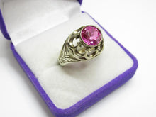 Load image into Gallery viewer, Angled view of an 875 silver amethyst ring showing the round faceted stone, bezel setting and engraved leaf shoulder.