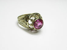 Load image into Gallery viewer, Vintage 875 silver amethyst ring on a white surface, showing the round stone, scalloped openwork and broad decorated band.