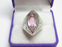 Load image into Gallery viewer, Front view of a vintage 875 silver amethyst cabochon ring with engraved shoulders in a purple and white jewelry box.