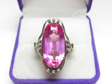 Load image into Gallery viewer, Front view of a vintage 875 silver amethyst ring with an elongated oval stone and beaded frame in a purple jewelry box.
