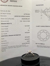 Load image into Gallery viewer, A close-up of a diamond ring displayed on top of a black circular box, with an IGI Institute laboratory grown diamond report sheet behind it showing grading details and diamond proportion diagrams.