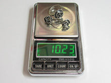 Load image into Gallery viewer, A silver-toned digital scale showing the weight of a three-ring silver rose cluster jewelry piece, with the display reading 10.23 grams.
