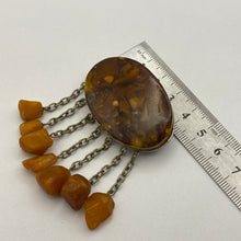 Load image into Gallery viewer, Vintage USSR Baltic Amber brooch with dangle chains, natural amber jewelry featuring intricate design and statement style.
