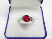 Load image into Gallery viewer, Close-up of Vivid Pink-Magenta Round Faceted Tourmaline on Vintage 875 Silver Bezel Ring
