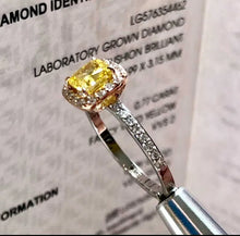 Load image into Gallery viewer, Close-up of 0.77ct Fancy Vivid Yellow Lab-Grown Diamond with Halo on Two-Tone 14K Gold Ring
