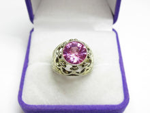 Load image into Gallery viewer, Front view of a vintage 875 silver round amethyst ring with decorative openwork and bead accents in a purple jewelry box.
