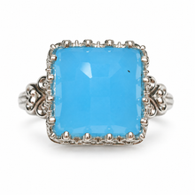 Load image into Gallery viewer, Vintage 925 sterling silver cocktail ring featuring a large cushion-shaped faceted sky-blue agate, decorative silver prong setting, and ornate scrollwork shoulders, size 8.5.

