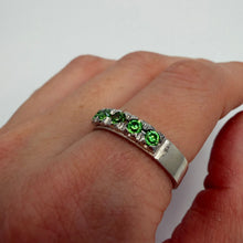 Load image into Gallery viewer, Vintage 925 sterling silver eternity ring with green peridot gemstones, size 9.5, featuring a sleek band and vibrant green accents.
