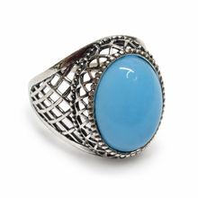 Load image into Gallery viewer, Side view of vintage 925 sterling silver blue agate statement ring with a raised oval cabochon, diamond-pattern openwork, and ornate silver beading.
