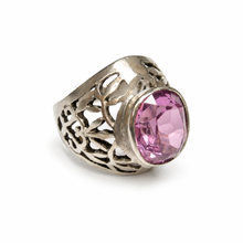 Load image into Gallery viewer, Side view of a vintage Soviet 875 silver amethyst ring with a raised oval pink gemstone and intricate floral openwork detailing on a wide silver band.
