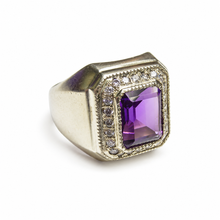 Load image into Gallery viewer, Side view of vintage Soviet 875 silver amethyst signet ring with raised rectangular purple gemstone, decorative clear stone halo, and wide polished silver band.
