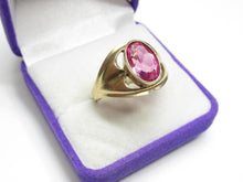 Load image into Gallery viewer, Angled view of an 875 silver gilt amethyst ring showing the faceted oval stone, raised bezel and sweeping shoulders.
