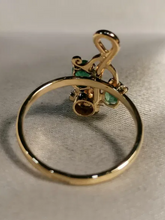 Load image into Gallery viewer, Close-up of Natural Oval Emeralds and Old-Cut Diamond on Antique Imperial 56 Gold Floral Ring
