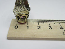 Load image into Gallery viewer, Side profile of an 875 silver round amethyst ring beside a metric ruler, showing the bezel and openwork setting.
