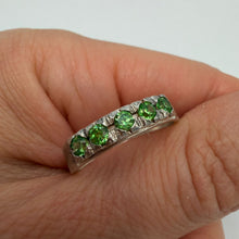 Load image into Gallery viewer, Sterling silver eternity ring with green peridot gemstones, size 9.5, showcasing a continuous band of vibrant green stones.
