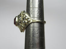 Load image into Gallery viewer, Side view of an 875 silver gilt amethyst ring on a sizing mandrel, showing the openwork leaf shoulder and bead accents.
