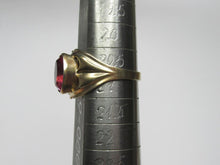 Load image into Gallery viewer, Side view of an 875 silver gilt amethyst ring on a sizing mandrel, showing the raised bezel and sculpted shoulder.
