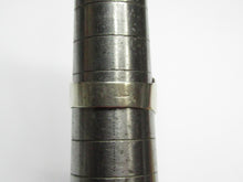 Load image into Gallery viewer, Rear view of a vintage 875 silver amethyst cabochon ring on a sizing mandrel, showing the plain band and surface wear.
