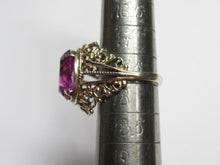 Load image into Gallery viewer, Side profile of an 875 silver gilt amethyst ring on a sizing mandrel, showing the raised stone and split shoulders.
