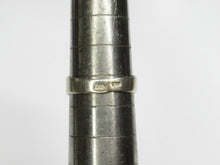 Load image into Gallery viewer, Close-up of stamped hallmarks on the gilt band of a vintage geometric amethyst ring resting on a sizing mandrel.
