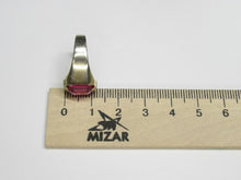 Load image into Gallery viewer, Side profile of an 875 silver gilt emerald-cut amethyst ring beside a metric ruler, showing the stone setting and band.
