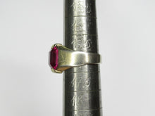 Load image into Gallery viewer, Side view of an 875 silver gilt amethyst ring on a sizing mandrel, showing the broad shoulder and raised gemstone.

