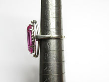 Load image into Gallery viewer, Side view of an 875 silver amethyst ring on a sizing mandrel, showing the slim band and raised open frame.

