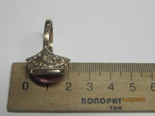 Load image into Gallery viewer, Side profile of an 875 silver gilt amethyst cabochon ring beside a metric ruler, showing the domed stone and filigree.
