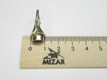 Load image into Gallery viewer, Side profile of an 875 silver gilt oval amethyst ring beside a metric ruler, showing the bezel and openwork shoulder.
