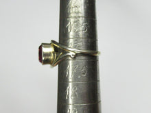 Load image into Gallery viewer, Side view of an 875 silver gilt amethyst ring on a sizing mandrel, showing the raised bezel and curved shoulder.

