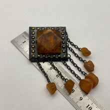 Load image into Gallery viewer, Vintage USSR Baltic amber dangle brooch with brutalist silver setting, featuring natural amber stones and a bold statement design.
