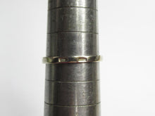 Load image into Gallery viewer, Close-up of stamped hallmarks on the band of a vintage gilt silver ring resting on a sizing mandrel.
